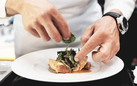 Chef is decorating delicious dish, toned