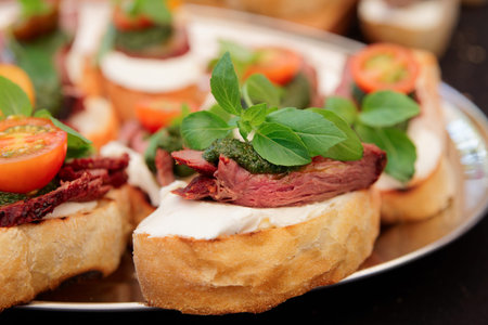 Bruschettas with beefsteak and pesto sauce, close-up