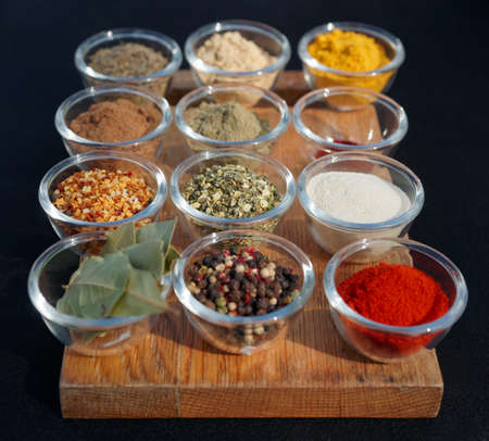 Set of various spices on wooden plankの写真素材