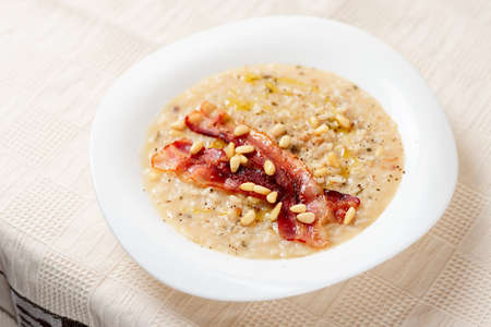 Risotto with bacon and pine nuts in plateの写真素材