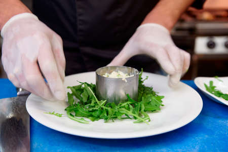 Chef is cooking appetizer at commercial kitchenの写真素材