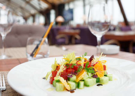 Tuna tartar with cucumber and orange on restaurant tableの写真素材