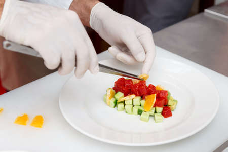 Chef is cooking tuna appetizer at professional kitchenの写真素材