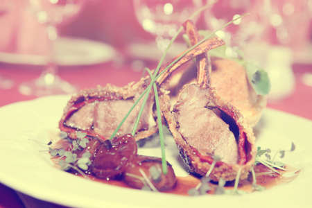 Rack of lamb with caramelized onions and homemade bun, toned imageの写真素材