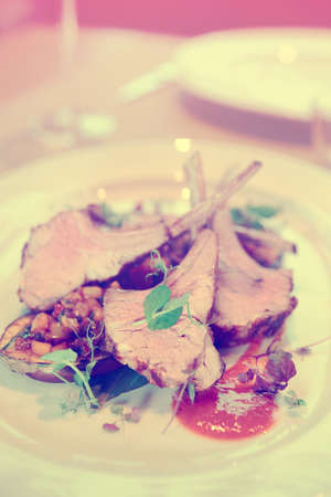 Grilled rack of lamb with vegetables on plate, toned pictureの写真素材