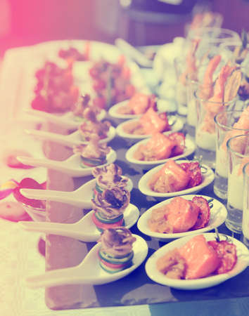 Spoons with seafood snacks -  banquet dish, toned imageの写真素材