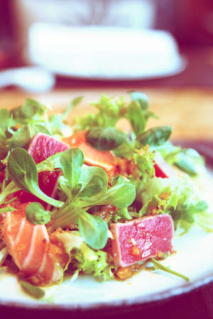 Appetizer with rare fried tuna and salmon , close-up, toned imageの写真素材