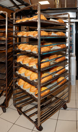 Steel rack with freshly baked bread, commercial kitchen