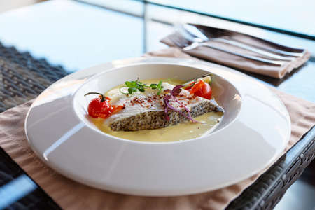 Chilean seabass fillet in plate on restraurant tableの写真素材