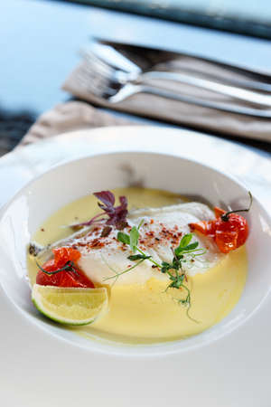 Chilean seabass fillet in plate on restraurant tableの写真素材