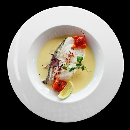 Chilean seabass fillet in plate, isolated on black backgroundの写真素材