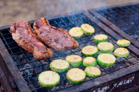 Meat and zucchini slices on grillの写真素材