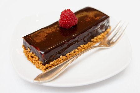 Piece of chocolate cake in small plate, close-up