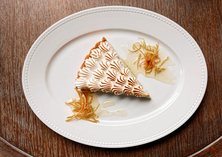 Meringue dessert on wooden table, toned image