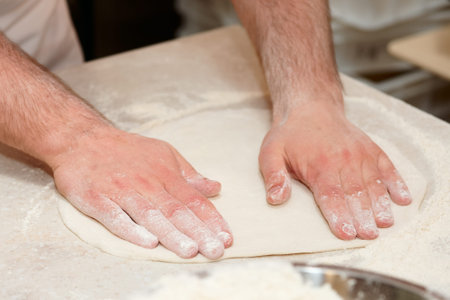 Chef is cooking pizza, forming doughの写真素材