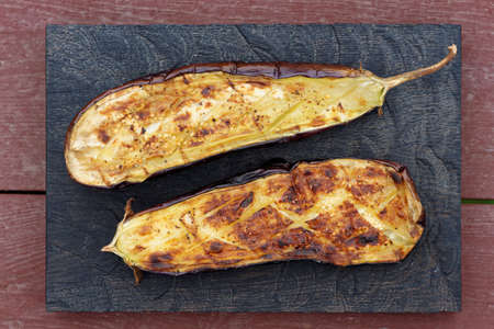 Grilled eggplant on wooden board shot from aboveの写真素材