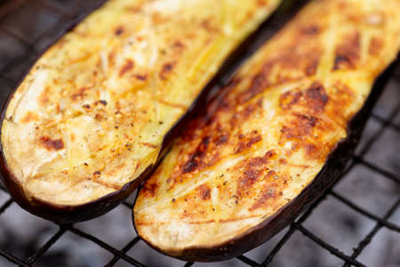 Eggplant being fried on grill, close-upの写真素材