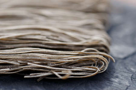 Squid ink pasta on wooden board, macro shotの写真素材