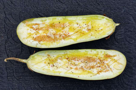 Eggplant prepared for grilling - seasoned with spices, garlic and olive oilの写真素材