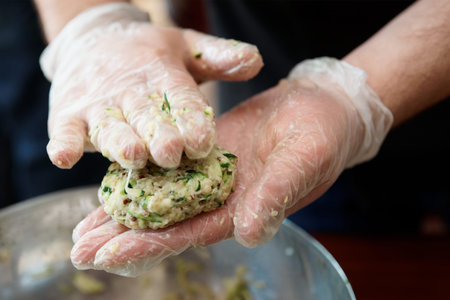 Chef is cooking zucchini fritters, motion blur