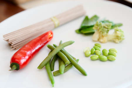 Ingredients for a vegetarian dish on plateの写真素材
