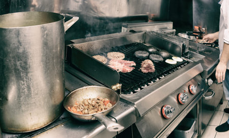 Real kitchen of bar and grill restaurant in operation, toned image