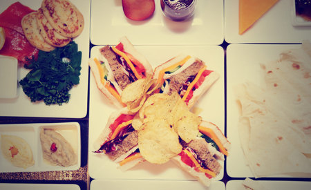 Sandwiches and appetizers on banquet table, shot from above, toned image