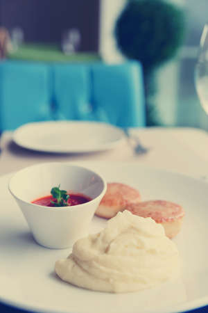 Lightly seared cutlets and potato mash on restaurant table, toned imageの写真素材