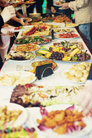 Table setting for banquet - fruits and appetizers, toned imageの写真素材