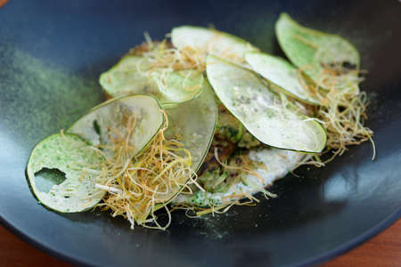 Creative gourmet vegetarian appetizer on black porcelain plateの写真素材