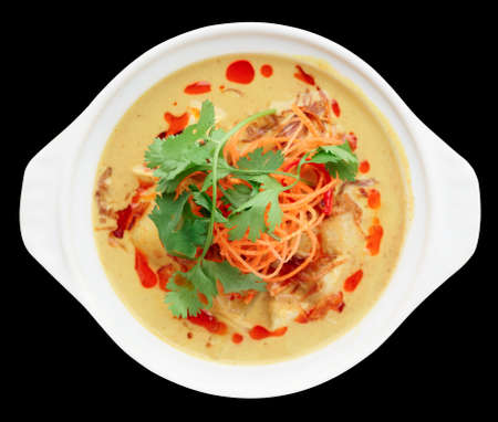 Bowl of  Tom Yam, spicy curry dish, shot from above isolated on black background with clipping pathの写真素材
