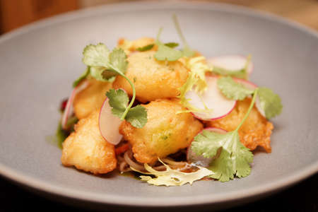 Fish tempura in grey porcelain plateの写真素材