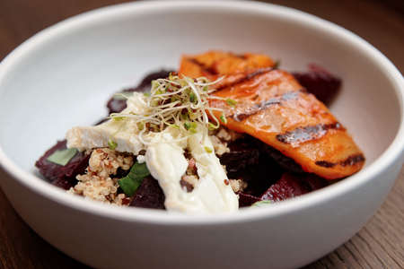 Appetizer of baked beetroot and grilled pear in porcelain plateの写真素材