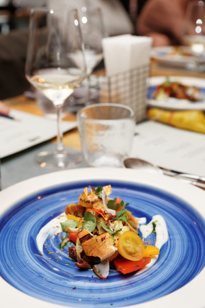 Chicken salad on blue plate, restaurant place setting, dinner