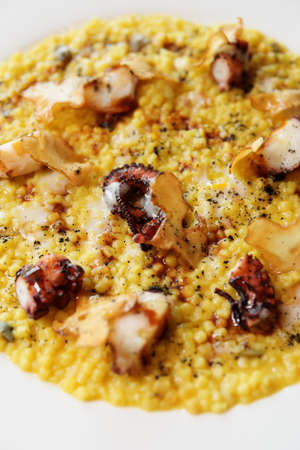 Fregola pasta cooked in risotto style with grilled octopus, Sardinian dishの写真素材