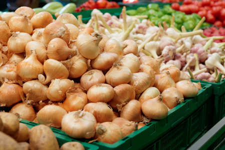 Shelf with onion and garlic in supermarketの写真素材