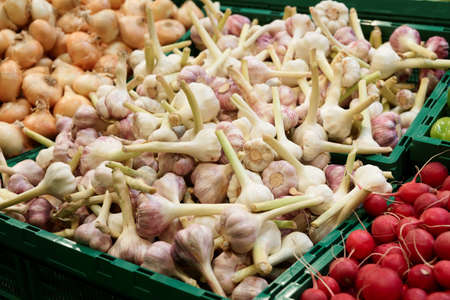 Shelf with onion and garlic on organic food marketの写真素材