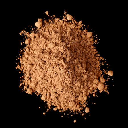 Pile of cocoa powder isolated on black background, shot from aboveの写真素材