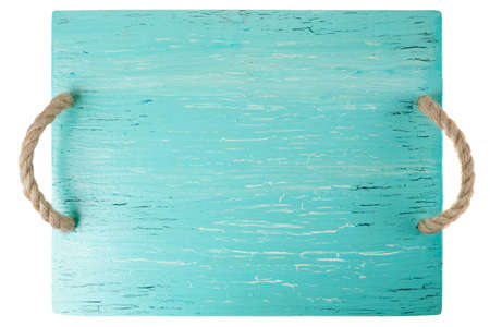 Wooden chopping board painted with turquoise paint isolated on whiteの写真素材