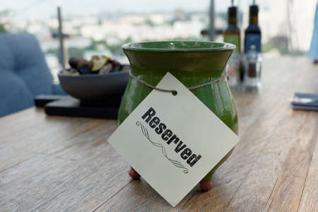 Reserved sign on restaurant table, outdoor summer terraceの写真素材
