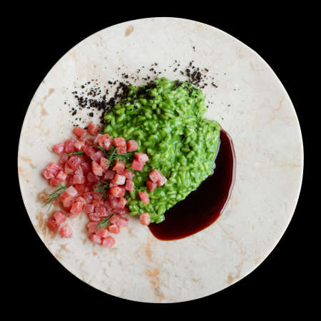 Spinach risotto with raw tuna fillet and teriyaki in marble plate, isolated on blackの写真素材