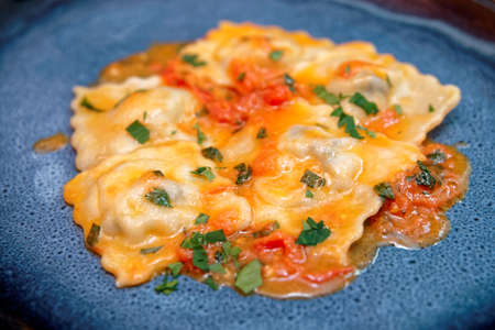 Ravioli in dark blue plate, close-upの写真素材