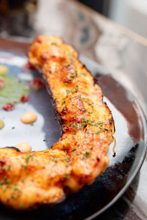 Grilled crab leg with cheese and green leekの写真素材