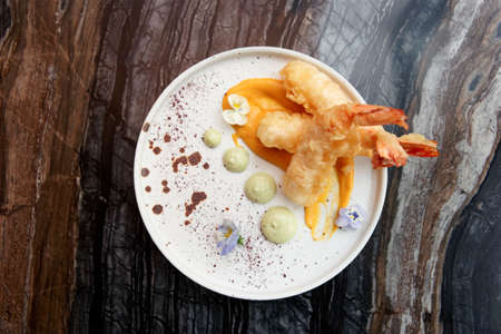 Deep fried shrimps in white plate on marble table shot from aboveの写真素材