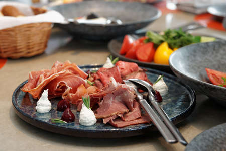 Assortment of cured and smoked meats and roast beef on stone plateの写真素材
