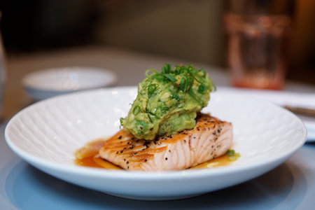 Grilled salmon steak with guacamole sauce in plate