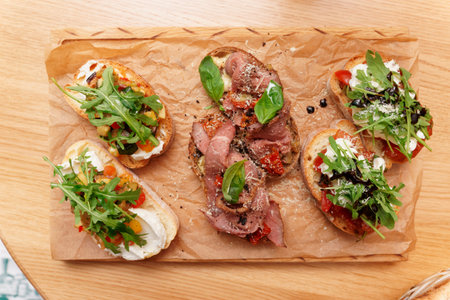 Bruschettas with beef, vegetables and creamy cheese shot from aboveの写真素材
