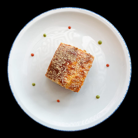 Slice of moussaka, traditional Greek and Balkan dish,  isolated on black background