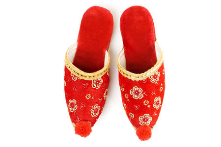Red embroidered Turkish slippers, decorative footwear isolated on whiteの写真素材