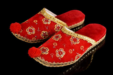Traditional Turkish slippers, decorative footwear, isolated on black backgroundの写真素材